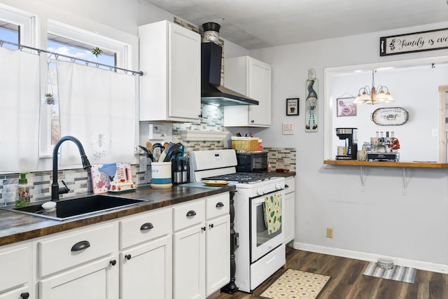 kitchen featuring white gas range oven, wall chimney exhaust hood, backsplash, and sink