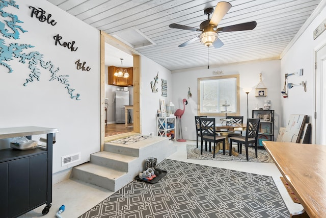 interior space with ceiling fan with notable chandelier