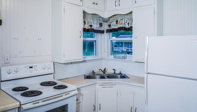 kitchen with sink, white appliances, and white cabinetry