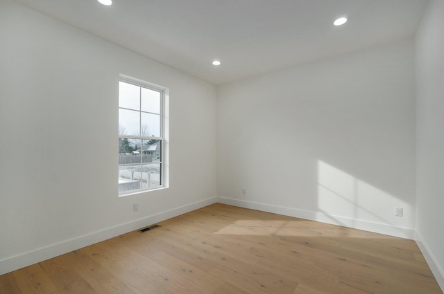 unfurnished room with light hardwood / wood-style floors