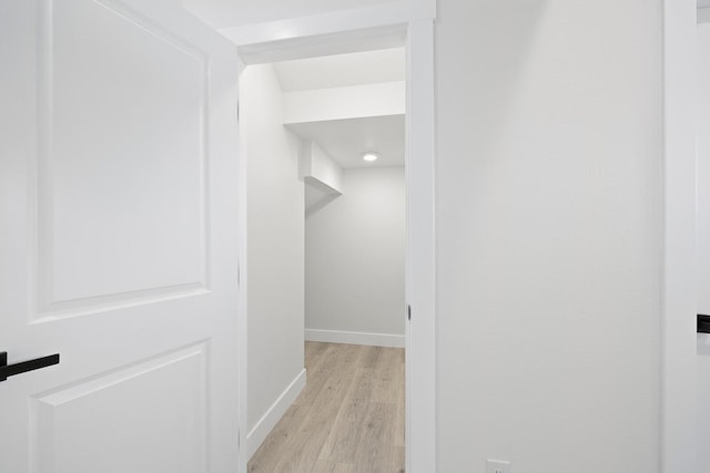 hallway with light hardwood / wood-style flooring