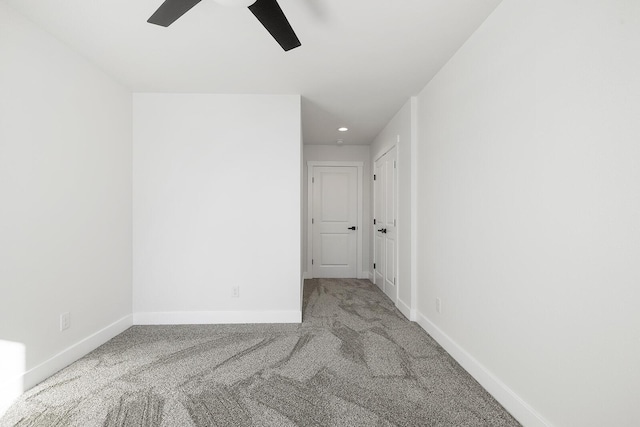 empty room with carpet floors and ceiling fan