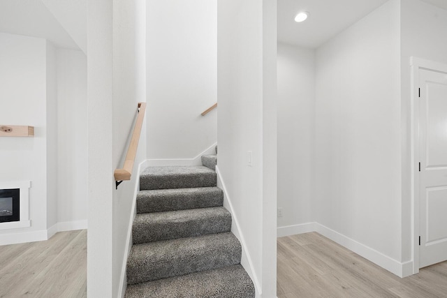 stairs with heating unit and hardwood / wood-style floors