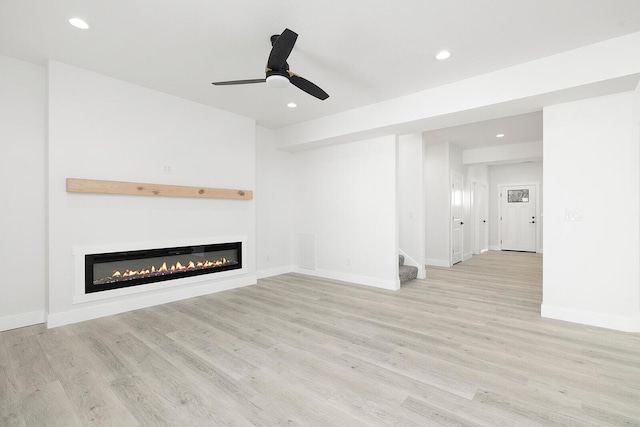 unfurnished living room with ceiling fan and light hardwood / wood-style flooring