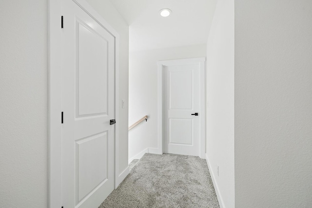 hallway with light colored carpet