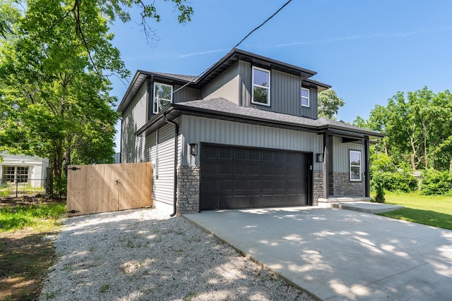1309 E Blaine St, Springfield, MO 65803 - view of front facade featuring driveway, stone siding, and an attached garage