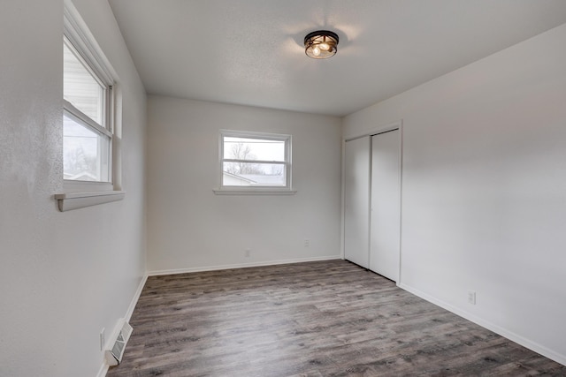 unfurnished room with wood-type flooring