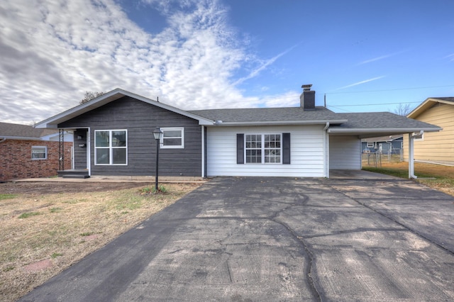 ranch-style house featuring a carport