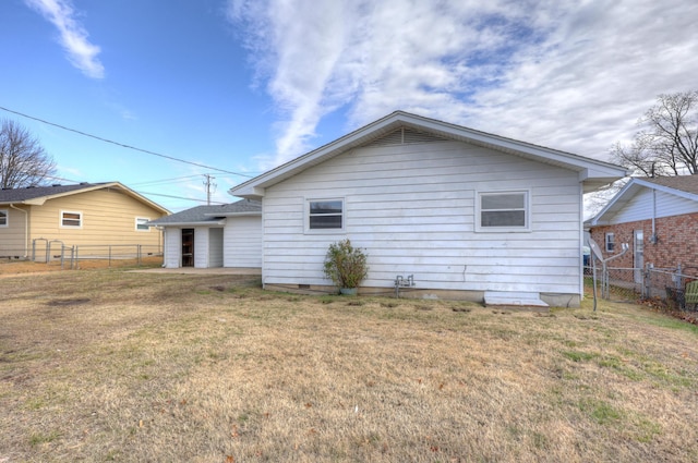 back of property with a lawn