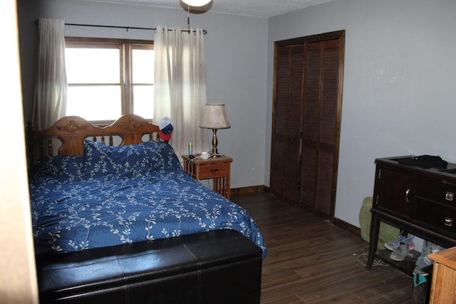 bedroom featuring dark hardwood / wood-style flooring and a closet