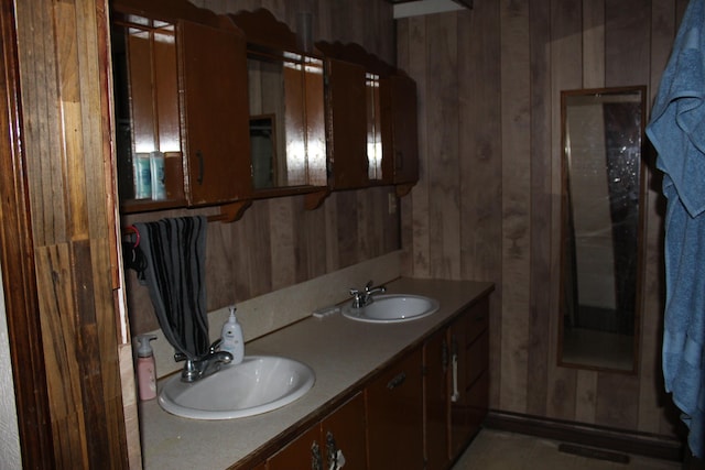 bathroom with wood walls and vanity