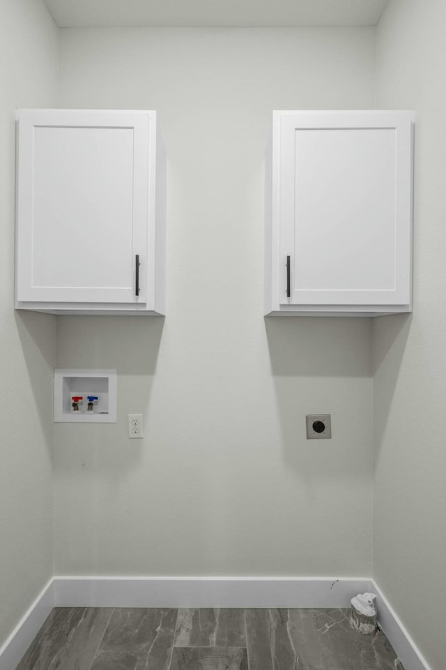 washroom featuring electric dryer hookup, washer hookup, and cabinets