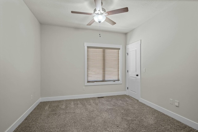 carpeted spare room featuring ceiling fan