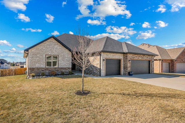 view of front of house with a shingled roof, concrete driveway, a front yard, fence, and a garage