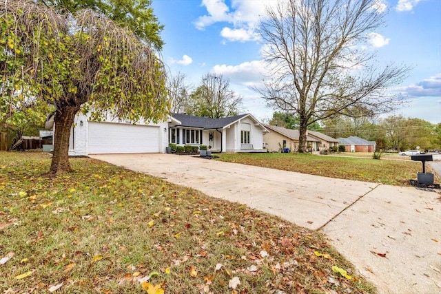 single story home featuring a front lawn and a garage