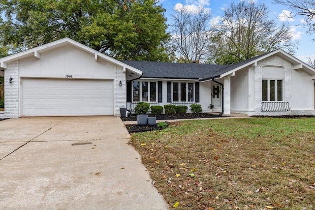 single story home featuring a garage and a front lawn