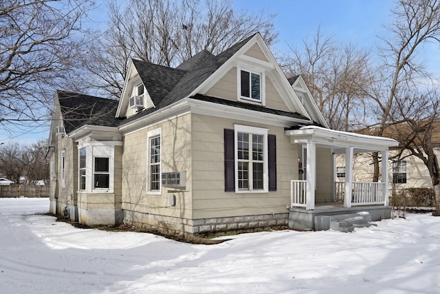 view of snow covered exterior featuring a porch