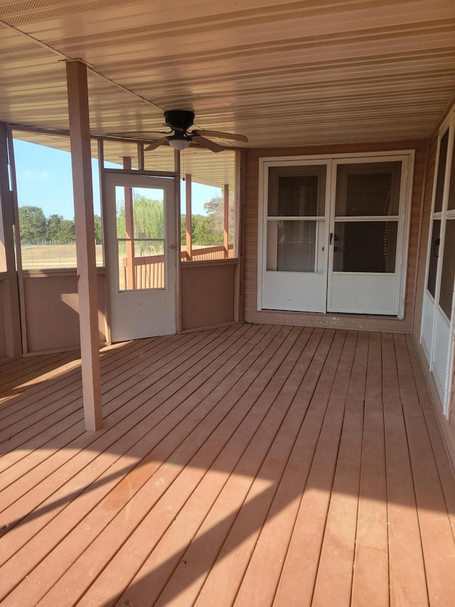 wooden terrace featuring french doors and ceiling fan