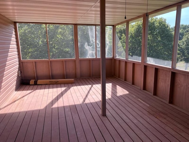 unfurnished sunroom with a water view