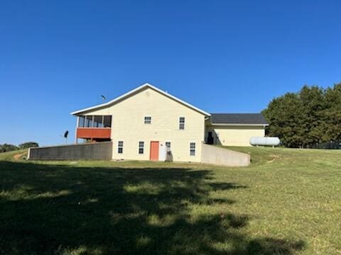 rear view of house with a lawn