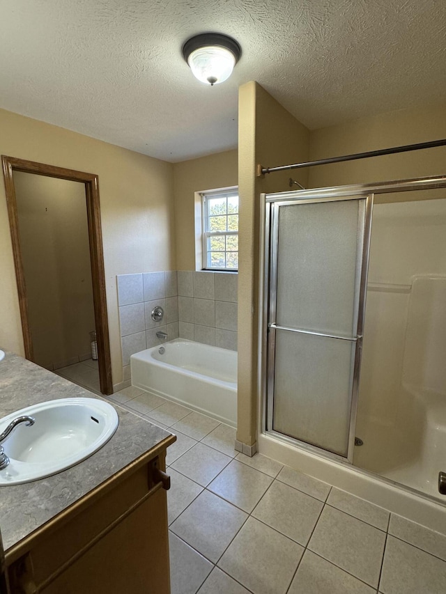 bathroom with tile patterned flooring, plus walk in shower, and vanity