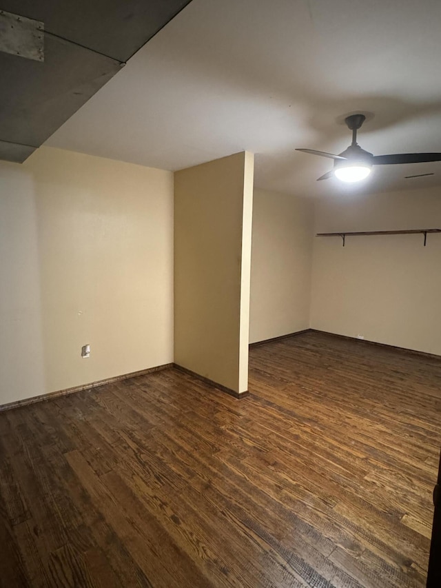 basement with ceiling fan and dark hardwood / wood-style flooring