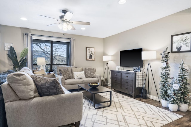 living room featuring hardwood / wood-style flooring and ceiling fan