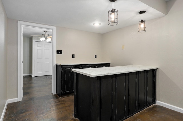 bar featuring pendant lighting, ceiling fan, and light stone countertops