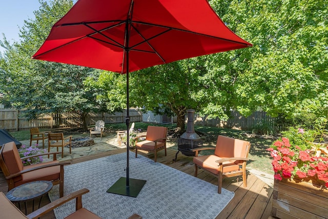 view of patio featuring a wooden deck and a fire pit