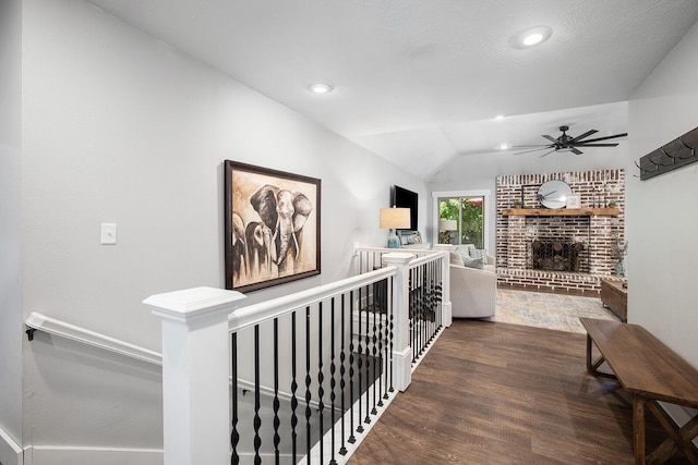 hallway featuring lofted ceiling and dark wood-type flooring