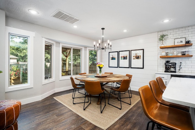 dining room featuring plenty of natural light, an inviting chandelier, and dark hardwood / wood-style flooring