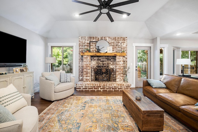 living room with dark wood-type flooring, lofted ceiling, and plenty of natural light