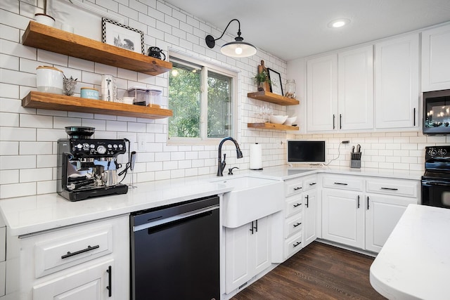 kitchen featuring sink, backsplash, dark hardwood / wood-style floors, black appliances, and white cabinets