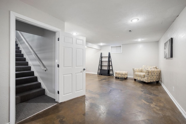 basement featuring a textured ceiling