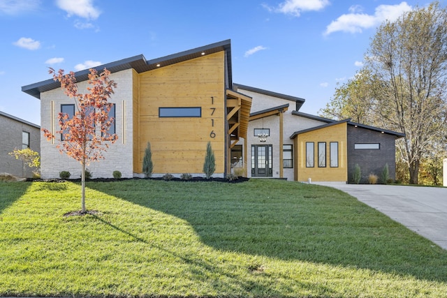 modern home featuring a front lawn and french doors