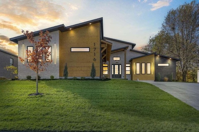 modern home featuring a lawn and a garage