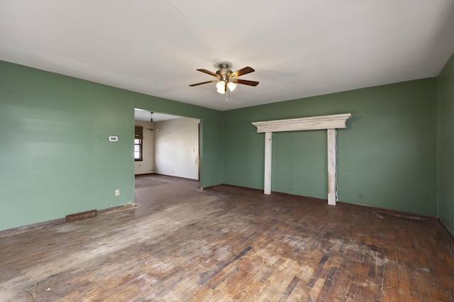 spare room with dark hardwood / wood-style flooring and ceiling fan