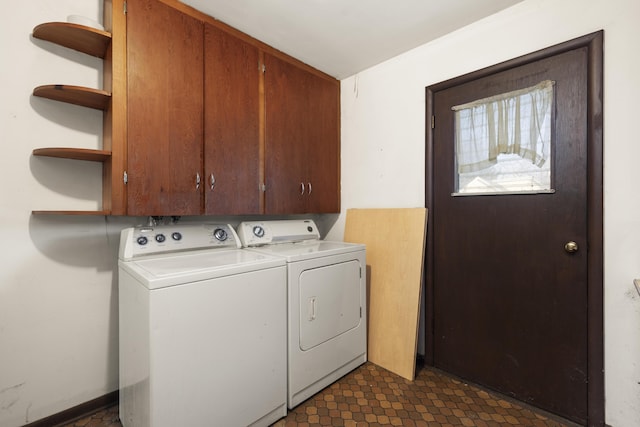 washroom featuring separate washer and dryer and cabinets