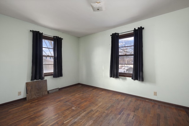 empty room with dark hardwood / wood-style floors