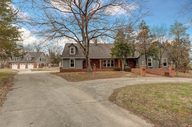 view of front of house with brick siding, board and batten siding, and a shingled roof