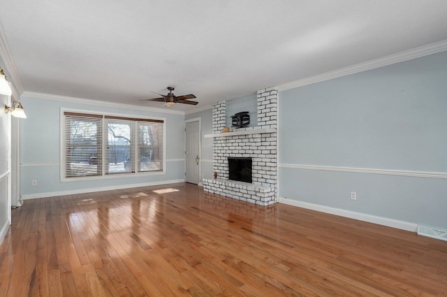 unfurnished living room featuring ornamental molding, a brick fireplace, a ceiling fan, and hardwood / wood-style flooring