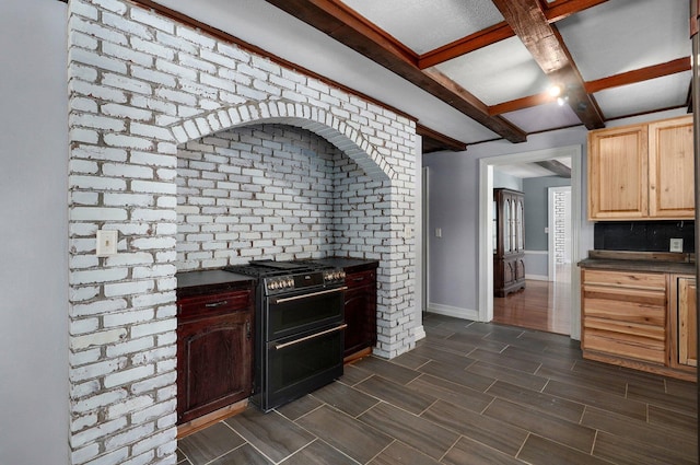 kitchen featuring double oven range, light brown cabinets, wood tiled floor, dark countertops, and beamed ceiling