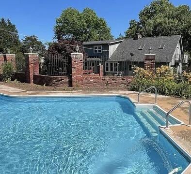 view of pool with a fenced in pool and fence