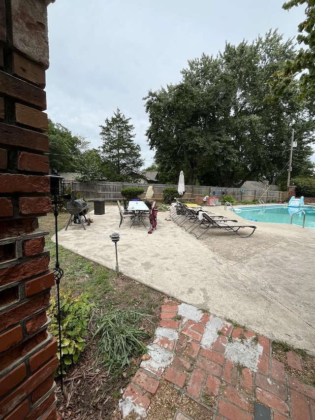 exterior space with a fenced in pool and fence