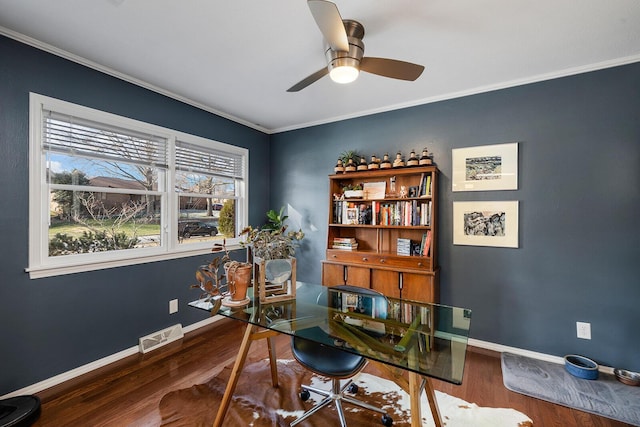 office area with baseboards, visible vents, dark wood finished floors, and ornamental molding