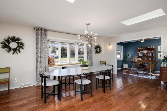 dining area with a chandelier, dark wood-style flooring, visible vents, and baseboards