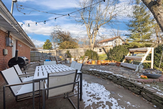 view of patio featuring outdoor dining area, grilling area, and a fenced backyard