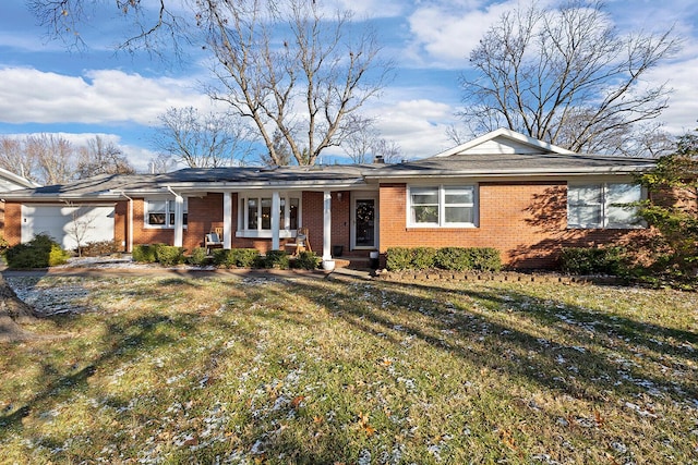 ranch-style house featuring brick siding and a front yard