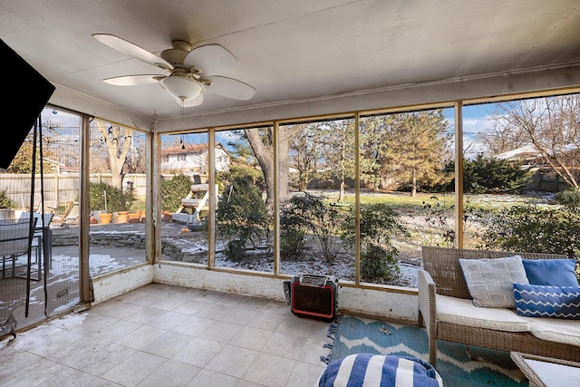 unfurnished sunroom with ceiling fan