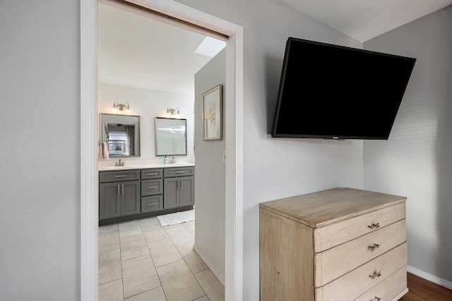 interior space with baseboards and a sink